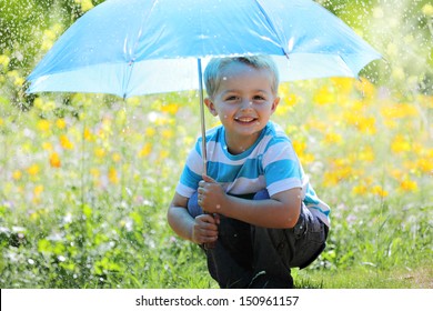 Rain and sunshine with a smiling boy holding an umbrella in a meadow of wildflowers