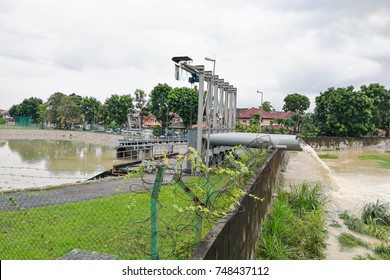 Rain Water Being Extracted Pumped Into River From Flood Storm Retention Pond After Rain.  Public Flood Management System In Malaysia.