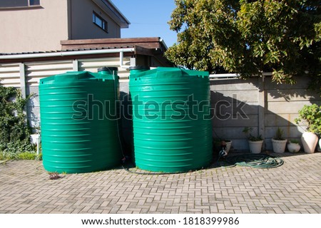 rain water catchment plastic tanks setup in backyard
