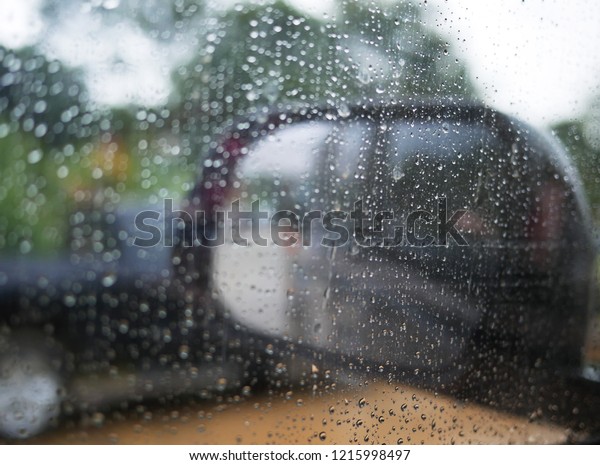 rain water drops on the car glass in a rainy\
day,select focus.