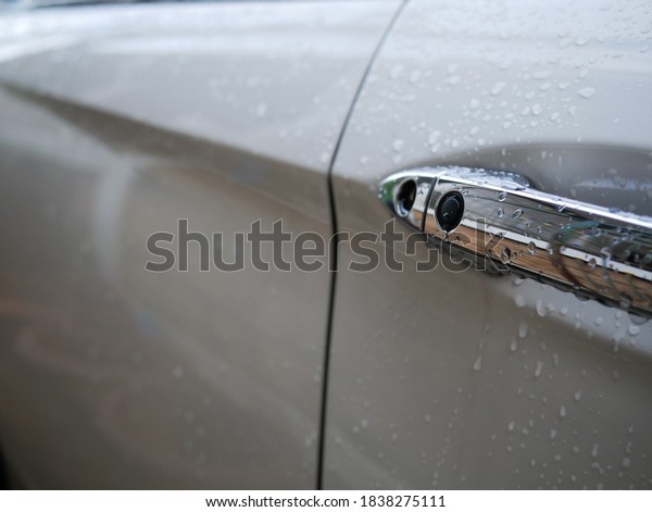 rain water drops on car\
door handle.
