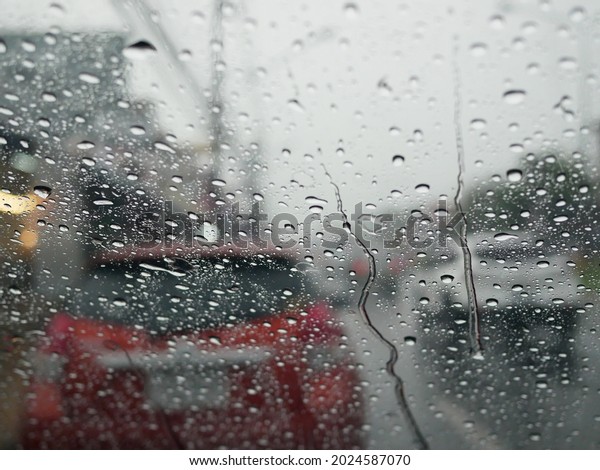 rain water drops on\
the car windshield.