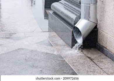 Rain Water Run Out Of A Downspout During A Thunderstorm