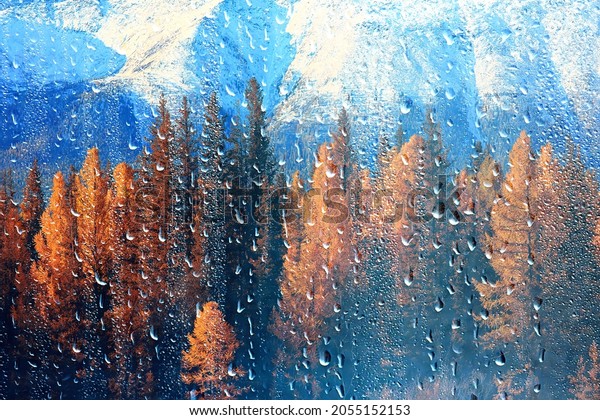 rain window view, water drops on\
glass view forest and mountains landscape\
background