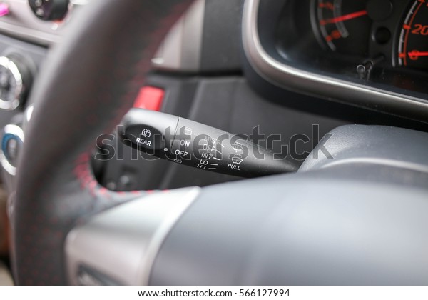 Rain windscreen wiper control\
stick with adjustable speed functions behind steering\
wheel.