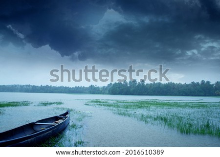 Rain - A wooden fishing boat under a dark cloudy sky, Beautiful landscape photography in rainy day, Monsoon photography in Kerala India