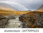 A rainbow above Guobirjohka river that crosses Kungsleden hiking trail, Lapland, Sweden