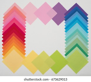  A Rainbow Abstract Flat Lay Out of Cotton Fabric Samples around bottom, top and side edges of a White Linen Background with room or space in center for copy, text or your words.  Horizontal crop ภาพถ่ายสต็อก
