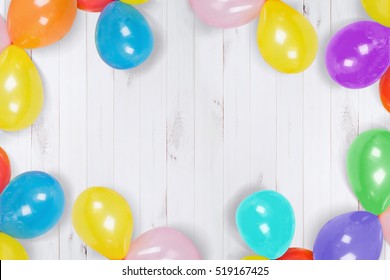 Rainbow Ballon On The Wooden Floor. High Top View. Holiday, Carnival Or Birthday Party Concept.