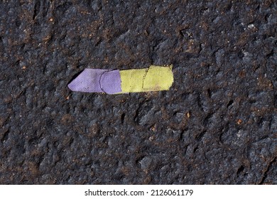 Rainbow Band Aid In A Parking Lot.