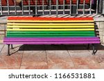 Rainbow bench painted in the colors of LGBT pride flag on Plaza de La Escandalera in Oviedo, Asturias, Spain