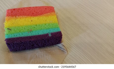 Rainbow Cake, On A Brown Paper Napkin.