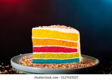 Rainbow cake portion in a studio shot