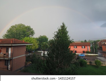 rainbow caused by reflection, refraction and dispersion of sun light in rain water droplets, resulting in spectrum of light in the sky in the form of a multicoloured circular arc