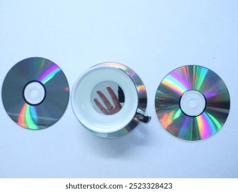 Rainbow CDs and cups on table