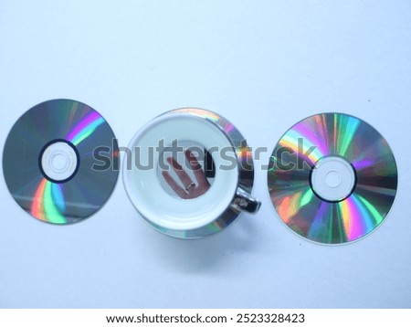Rainbow CDs and cups on table
