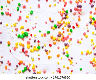 Rainbow colored candy nerds sprinkled on a white background. - Shutterstock ID 1961076880