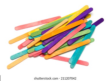 A Rainbow Colored Collection Of Painted Popsicle Craft Sticks Over White.