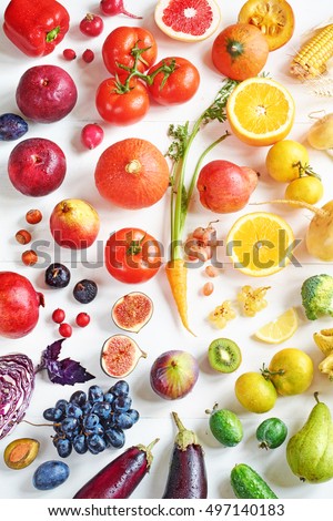 Rainbow colored fruits and vegetables on a white table. Juice and smoothie ingredients. Healthy eating / diet concept.