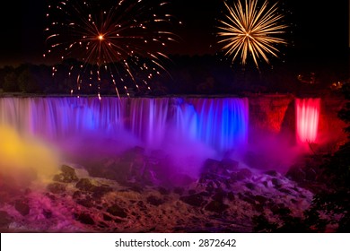 Rainbow Colored Niagara Falls With Fireworks Display