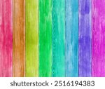 Rainbow coloured vibrant background texture - planks of wood in a rustic fence style backdrop running the gamut of hues. Represenation of full spectrum of colors from red to purple.