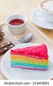 Rainbow crape cake with  coffee late on the wood table - Shutterstock ID 313493891