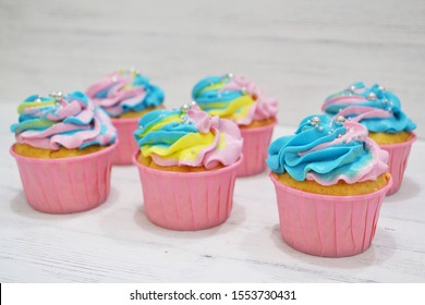 Rainbow Cupcakes With Shiny Sprinkles On It