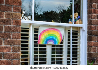 Rainbow drawing in a window- as a sign of hope during the 2020 Coronavirus outbreak (England, UK)