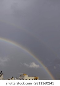 A rainbow in the evening caused due the the occurrence of sun and rain together. 