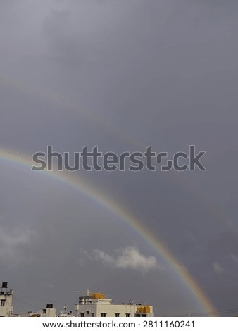 A rainbow in the evening caused due the the occurrence of sun and rain together. 