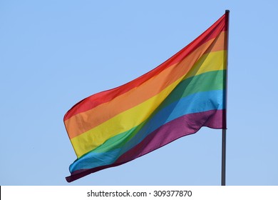 rainbow flag against the blue sky, symbol of tolerance and acceptance, diversity, hope and longing. The colors of this flag are specially for LGBT (Lesbian, Gay, Bisexual, Transgender) Pride.