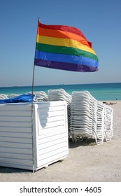 rainbow flag flutters in the wind at the beach