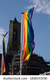 A Rainbow Flag In Front Of A Church