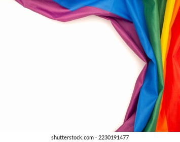 The rainbow flag or LGBT is on a white background with copy space for text. Top view. Close-up photo