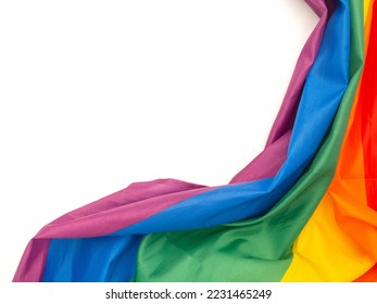 The rainbow flag or LGBT is on a white background with copy space for text. Top view. Close-up photo. Gender diversity concept - Shutterstock ID 2231465249