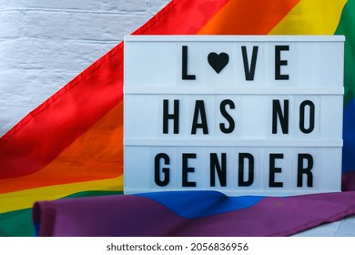 Rainbow flag with lightbox and text LOVE HAS NO GENDER. Rainbow lgbtq flag made from silk material. Symbol of LGBTQ pride month. Equal rights. Peace and freedom. Support LGBTQ community