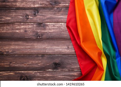 Rainbow Flag On Brown Wooden Table