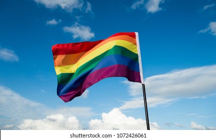 Rainbow Flag Waving On Sky