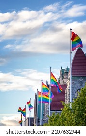 Rainbow Flags On Flagpoles In European City, Lgbt Pride Equal Rights Fight Against Discrimination Concept