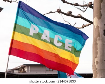 Rainbow Flags When In The Wind At A Peace Demonstration. The Word Pace Is Painted On The Flags. 