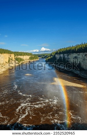 A rainbow forms in the mist above the Hay River as it cascades over Alexandra Falls in Canada's Northwest Territories