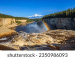 A rainbow forms in the spray as the Hay River cascades over the edge of Alexandra Falls, in Twin Falls Gorge Territorial Park, Northwest Territories