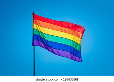 Rainbow Gay Pride Flag On Blue Sky Background, Miami Beach, Florida, USA