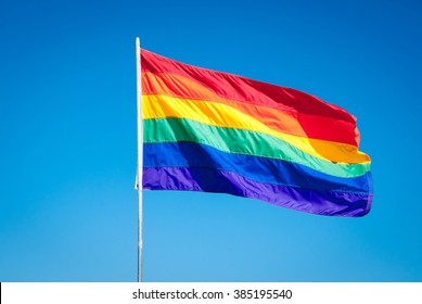 Rainbow Gay Pride Flag On Blue Sky Background