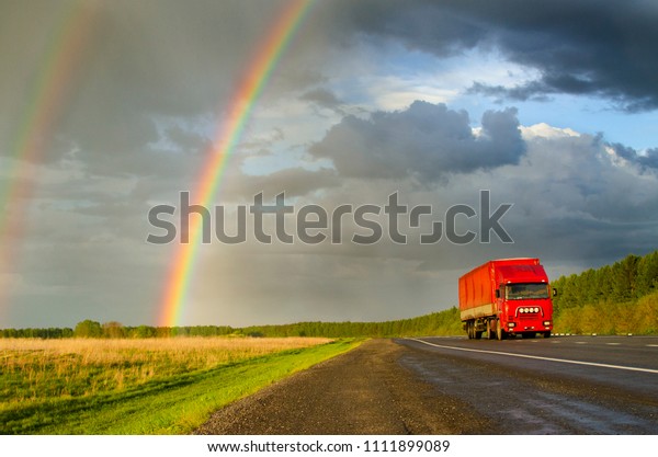 rainbow and gloomy sky\
above the road