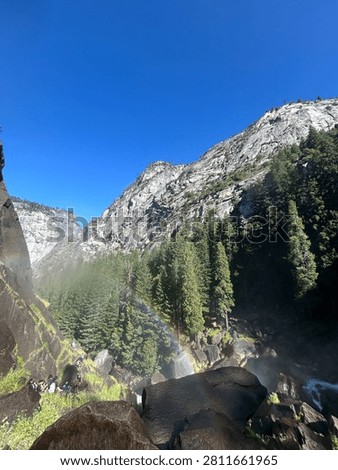 Rainbow and granite cliffs along the Mist Trail in Yosemite National Park, California during summer.
