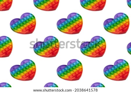 Rainbow heart shape isometric pattern of silicon toy for kids. Pop it fidget toy isolated on white background. Simle dimple toy. 
