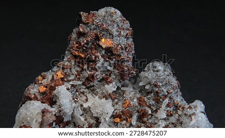 Rainbow iridescent chunks of the copper containing mineral bornite with colourless hexagonal crystals of quartz 