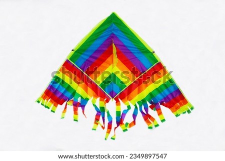 Rainbow kite triangular shape with bright multicolored coloring isolated on a white background. Sports Recreation Entertainment.