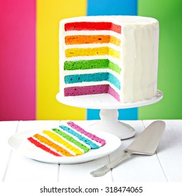 Rainbow layer cake on a cake stand